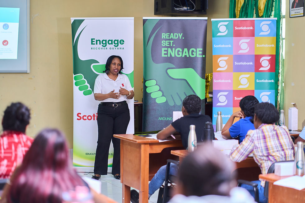 Shellon Garner, Finance Manager at Scotiabank Guyana training youths on financial management in Region 3.