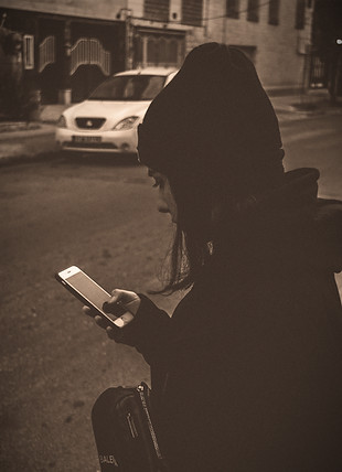 a person sitting on a bench looking at a