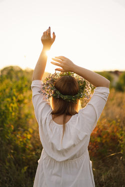woman-in-field-at-sunset-wearing-flower-crown-2026-03-09-08-45-17-utc