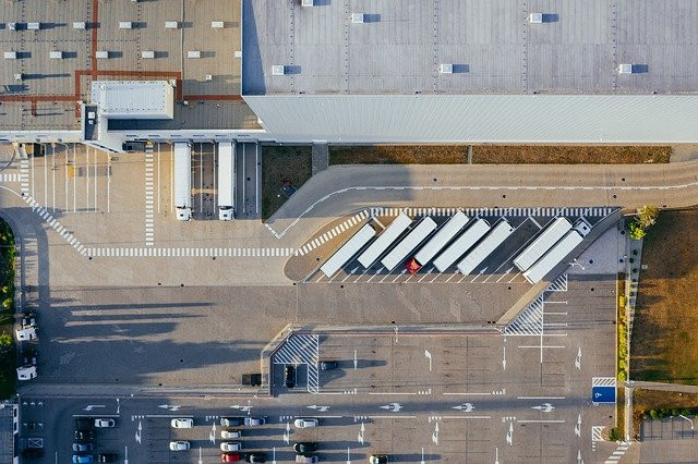 An aerial view of an organized truck parking lot, representing the benefits of logistics automation.