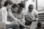 Happy diverse young friends students looking at laptop having fun on cafe terrace, multira