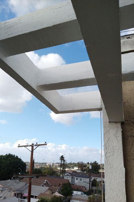 Image of a wooden structure heavily damaged due to pest or termite infestation. The wood shows clear signs of deterioration - it is hollowed out with visible tunnels and burrows, indicating a severe infestation. This image conveys the destructive potential of pests and the importance of pest control.