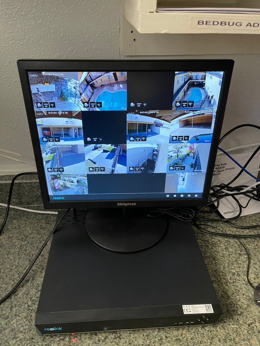 Smartology team member monitoring multiple cameras at a client store showcasing security solutions.