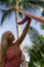 Female surfer posing with her surfboard