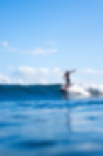 Male surfer riding down the line on a wave in Siargao, Philippines