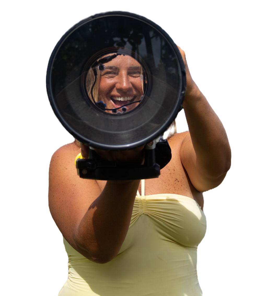 Sunshine Surf Sessions photographer looking through a camera housing underwater