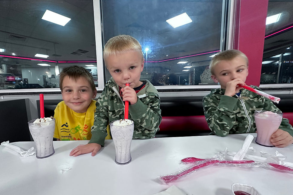 three boys at steak n shake with milkshakes