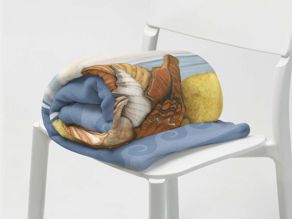 Thumbnail: Close-up view of a rolled-up Seashell Treasures throw blanket on a white chair.