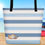 Thumbnail: “On Beach Time” tote bag near beach. Blue and white stripes and the words “on the beach”. Three seashells lower corner.