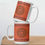 Thumbnail: Two Mandala (rustic orange) coffee mugs stacked on top of eachother, sitting on a wood cutting board.