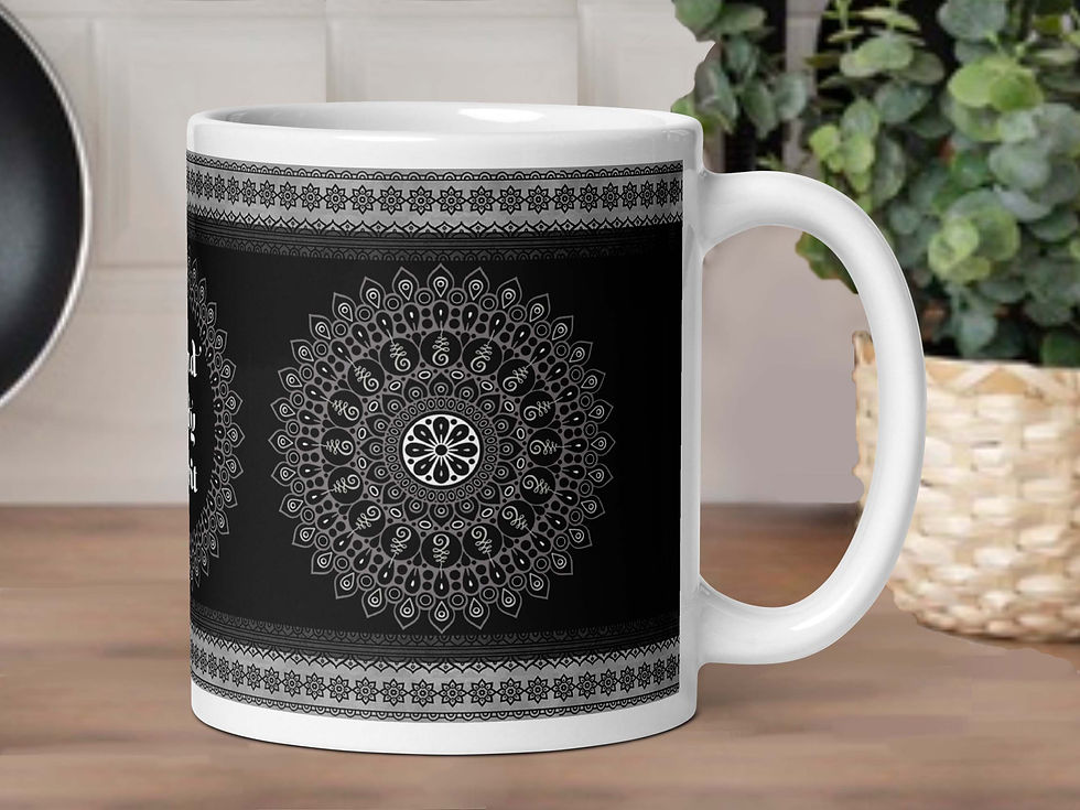 Thumbnail: A Mandala (black) coffee mug is sitting on a kitchen counter. A potted green plant is behind it.