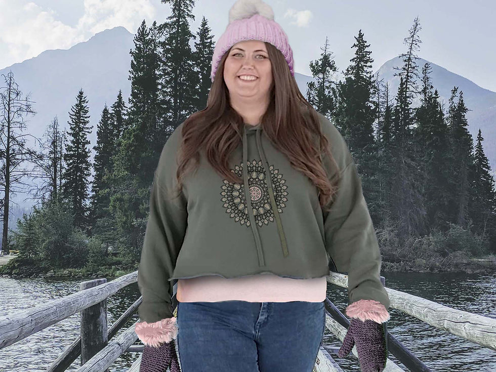 Thumbnail: Plus sized woman walking on a trail wearing army green Mandala cropped hoodie, hat and mittens. Winter sky, forest background