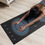 Thumbnail: A woman is in her living room doing a yoga child pose on the purple and blue Mandala yoga mat.