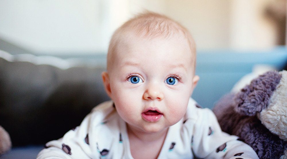 A smiling blue eyed baby