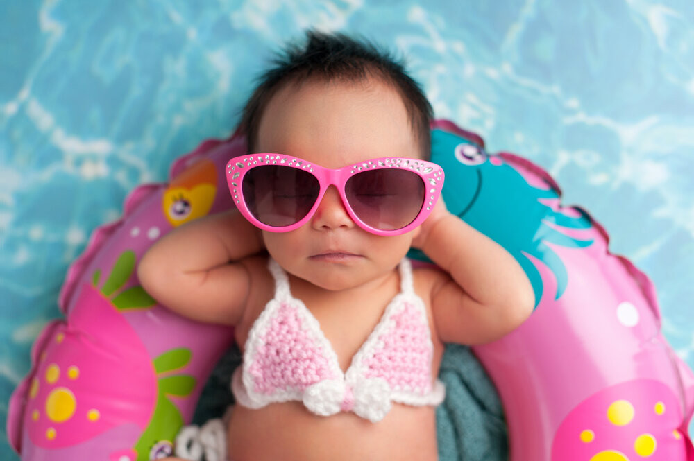 Baby laying in a floaty in a pool
