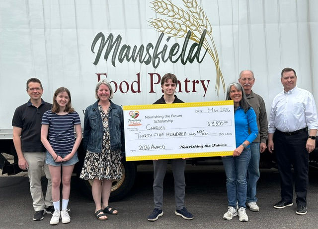 Charles shown here accepting the award with his family and Pantry volunteers.