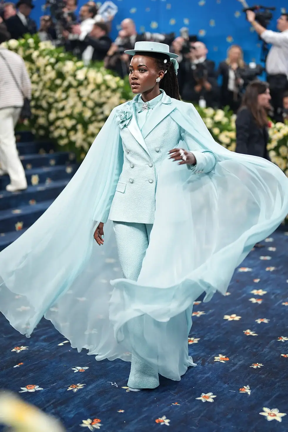 Actress Lupita Nyong’o (above) and singer Lauryn Hill (to the left) utilized bright spring colors in their beautifully tailored looks, making them stand out on the blue carpet.
