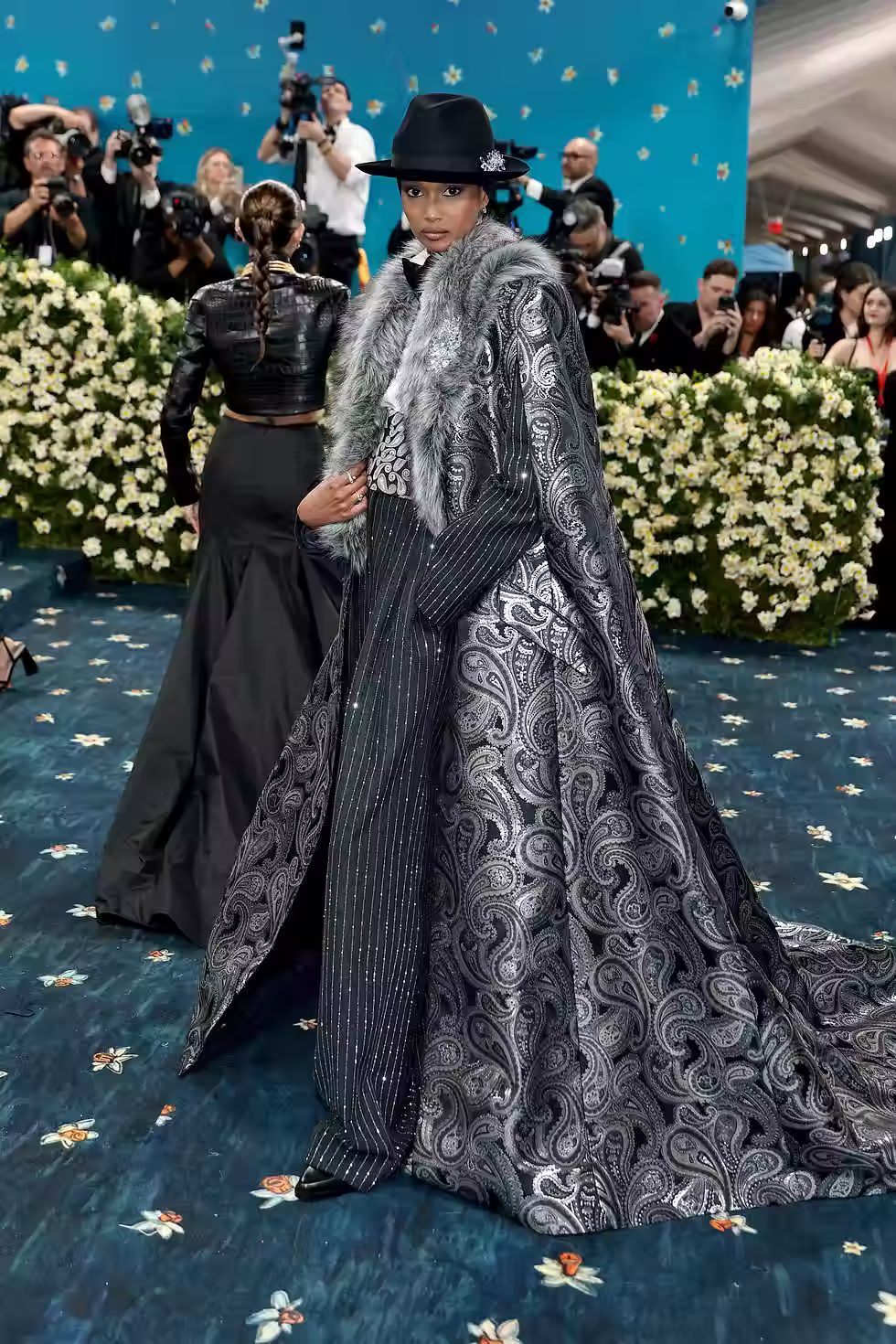 Model Ugbad Abdi’s glamorous look paid homage to André Leon Talley, who was known for wearing fantastic capes and cloaks.