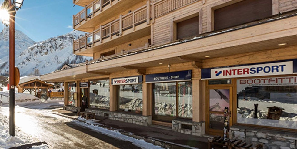 A photo of the street with ski rental shops at the base 