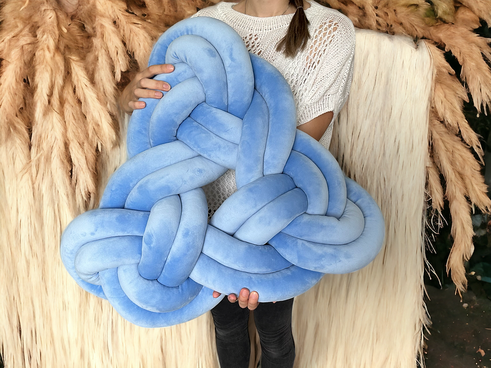 a person holding braided floor mat for meditation and relaxation on the fabric