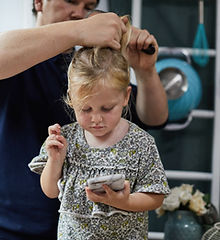 Father Combing Daughter's Hair