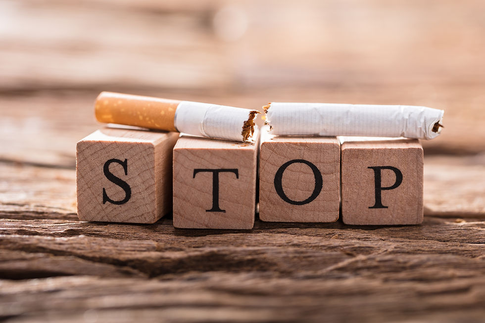 Close-up Of A Cigarette And Wooden Blocks Showing Stop Word On Desk.jpg