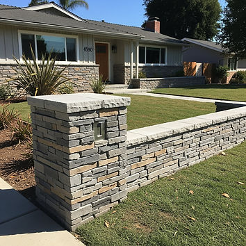 Professionally installed stone veneer on a residential site wall and column in Orange County, CA, showcasing high-quality masonry for home exteriors.