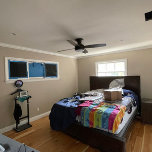 Newly painted room with a sherwin williams paint called shitake, and new natural hardwood flooring installed with freshly painted trim and moldings