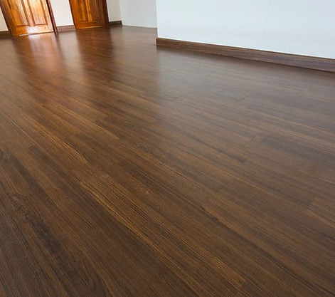 baseboard molding installed on new laminate flooring