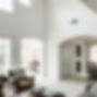 Photorealistic image of a freshly painted, bright, and airy living space in a Southern California residential home, showcasing clean white walls, ceilings, trim, and doors, with subtle signs of being lived-in.