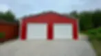 30 by 20 two-car metal garage with two roll-up doors and walk-in door