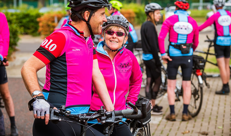 Two tandem cyclists chatting
