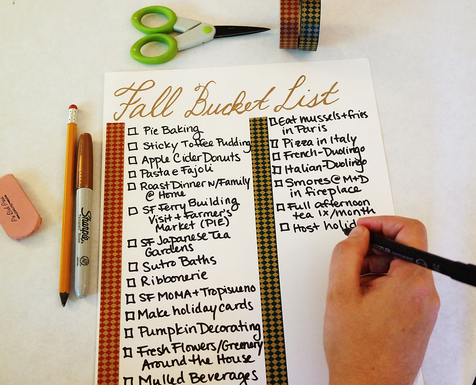 A sheet of paper titled Fall Bucket List on a white background with scissors, 2 rolls of washi tape, a copper Sharpie, pencil, and eraser.