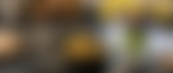 A bowl of Bulgur, Edamame, and Veggies meal. Spring decor. Flowers in a vase.