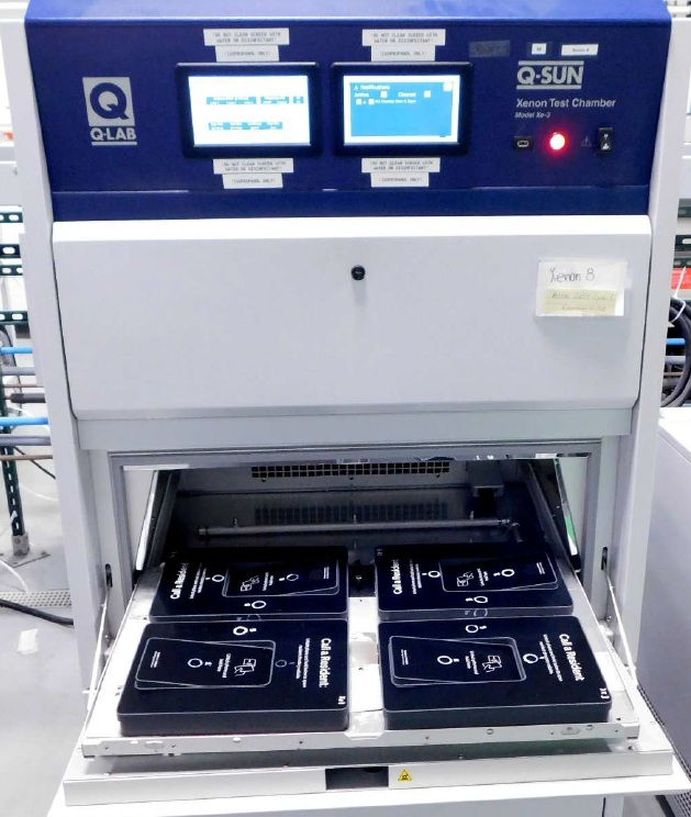 Xenon arc exposure chamber showing the door open and four electronic touch pads inside the chamber ready for testing
