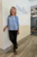 Dr. Joy Marshall, wearing a stethoscope and light blue blouse, stands smiling inside Tremont Functional Rehab & Health, where she recently moved her general practice.