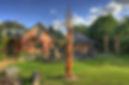Beautiful view of The Magic Garden, a modern spiritual temple featuring stunning wooden sculptures, big stones, and natural surroundings, supporting self-discovery and healing journeys.