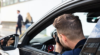 Private Detective Taking Photos Of Man And Woman On Street.jpg