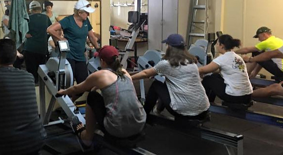 People on indoor rowing machines