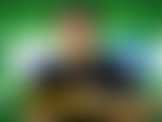 Smiling person holding a tablet pen against a green background with AI logos. Text: "AI in Software Development: What Freshers Need to Know in 2026."