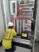 Electrical contractor working on electrical panel