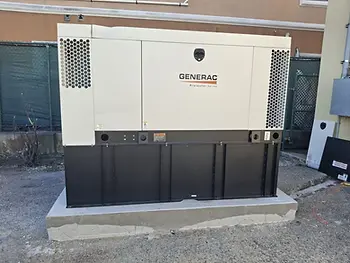Large Generac generator labeled "Protector Series" on concrete slab outdoors, fence and building in background. Beige and black with vent holes.