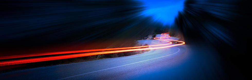 Cars light trails at night in a curve as