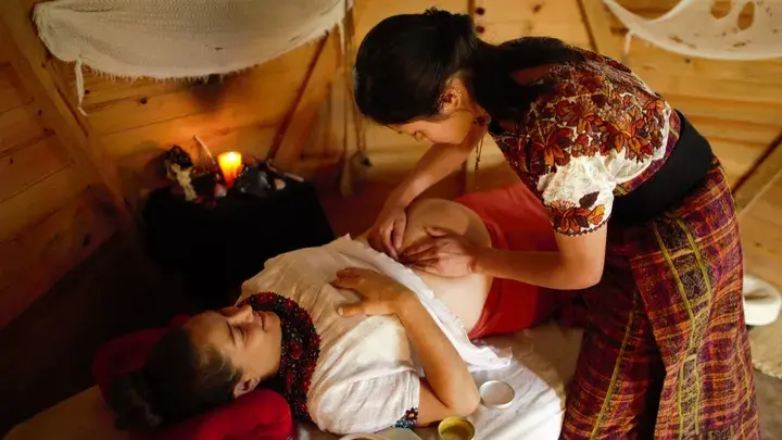 A midwife tending to a pregnant woman at Lake Atitlan in Guatemala, part of The Midwife Project