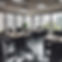 Office desks with computer programming being done, glass windows, empty desks.jpg
