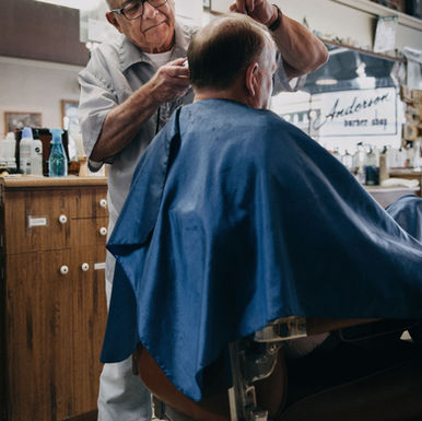 Barber cutting a client's hair — insurance for salons and service businesses