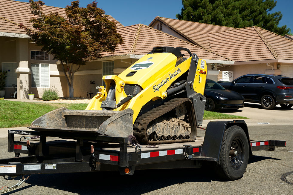 mini skid steer on deck over trailer