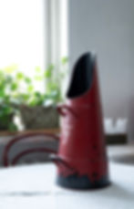 Tall vintage enamel pitcher in rustic red and black, featuring an 'F' monogram – perfect for farmhouse or country home decor