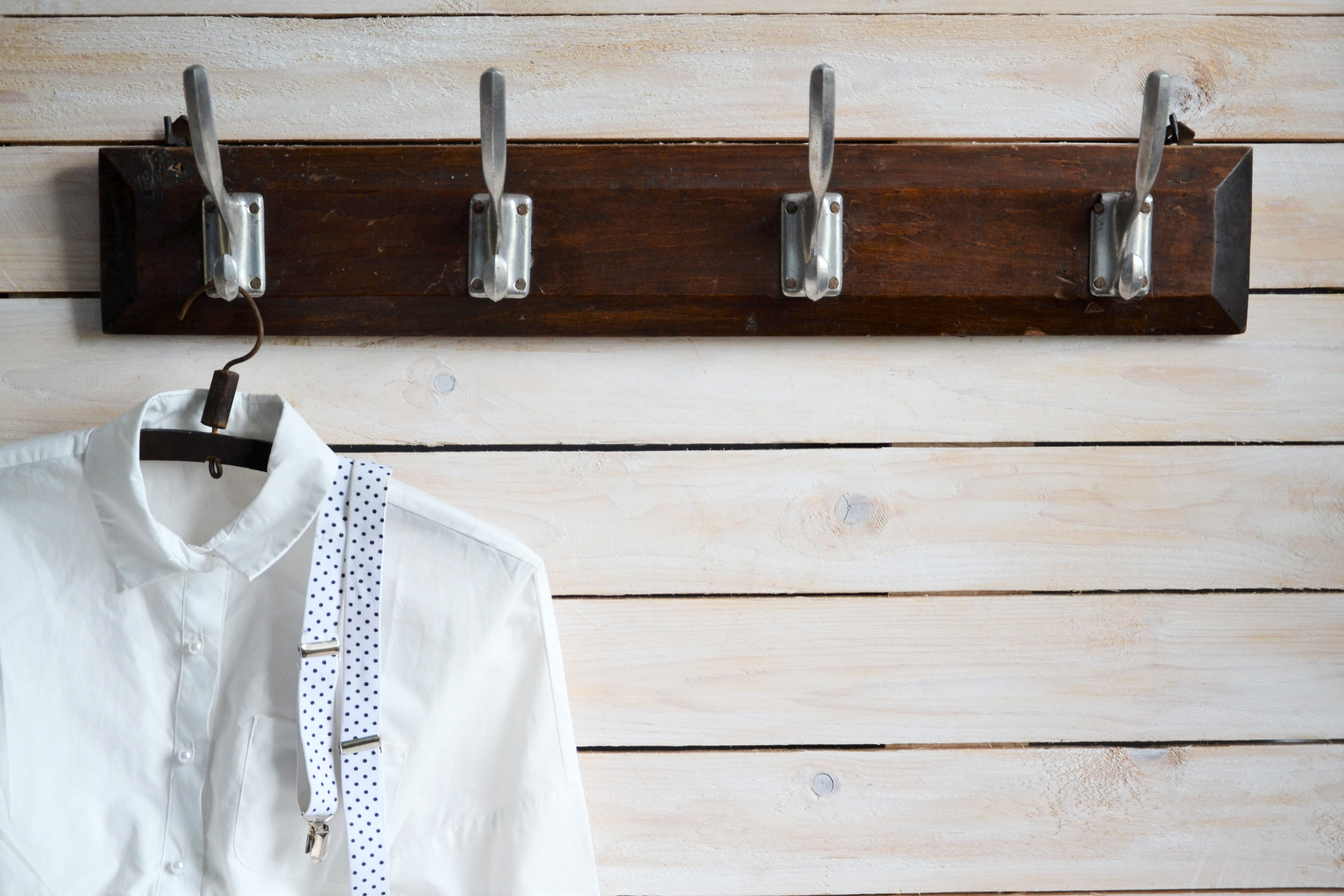 Vintage dark wooden wall rack with four metal hooks