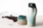 Vintage stoneware pottery jug with flowing turquoise glaze and small handle